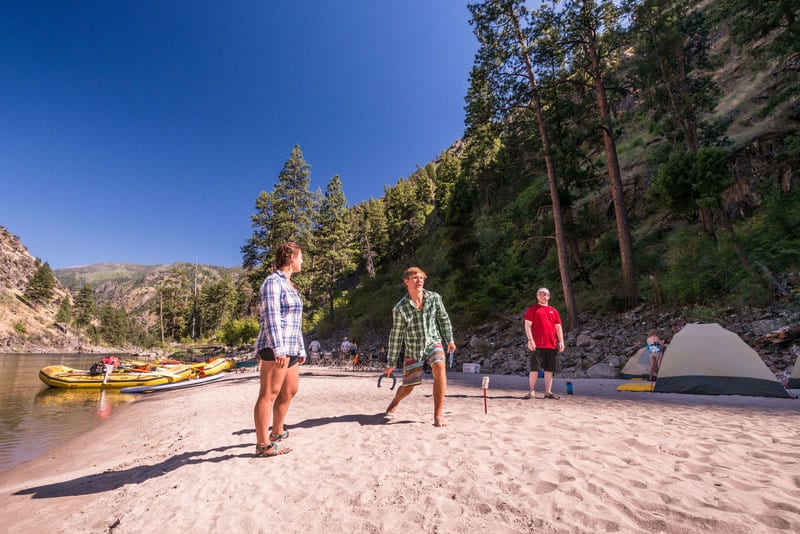 Couple playing horseshoes on a sandy Main Salmon River beach