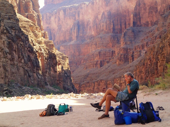 A man reading a book in Grand Canyon