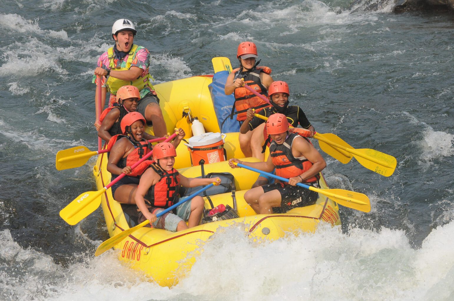 A yellow raft splashes through whitewater on Satan's Cesspool Rapid on the South Fork American River