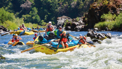 Oar rafts and inflatable kayaks tackle rapids on a family adventure down Oregon's Rogue River with OARS