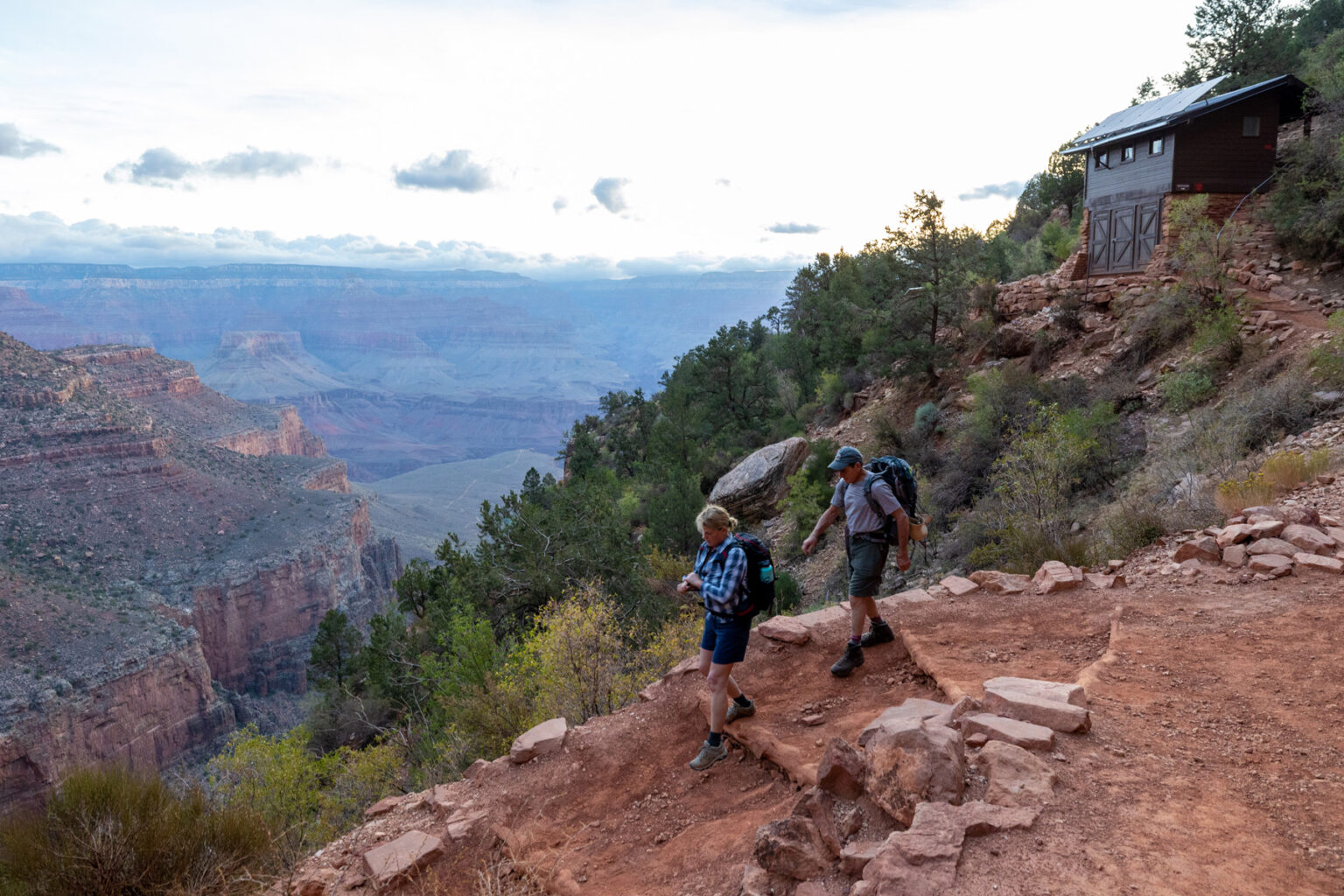 Man and woman begin their descent of the Bright Angel Trail in Grand Canyon National Park