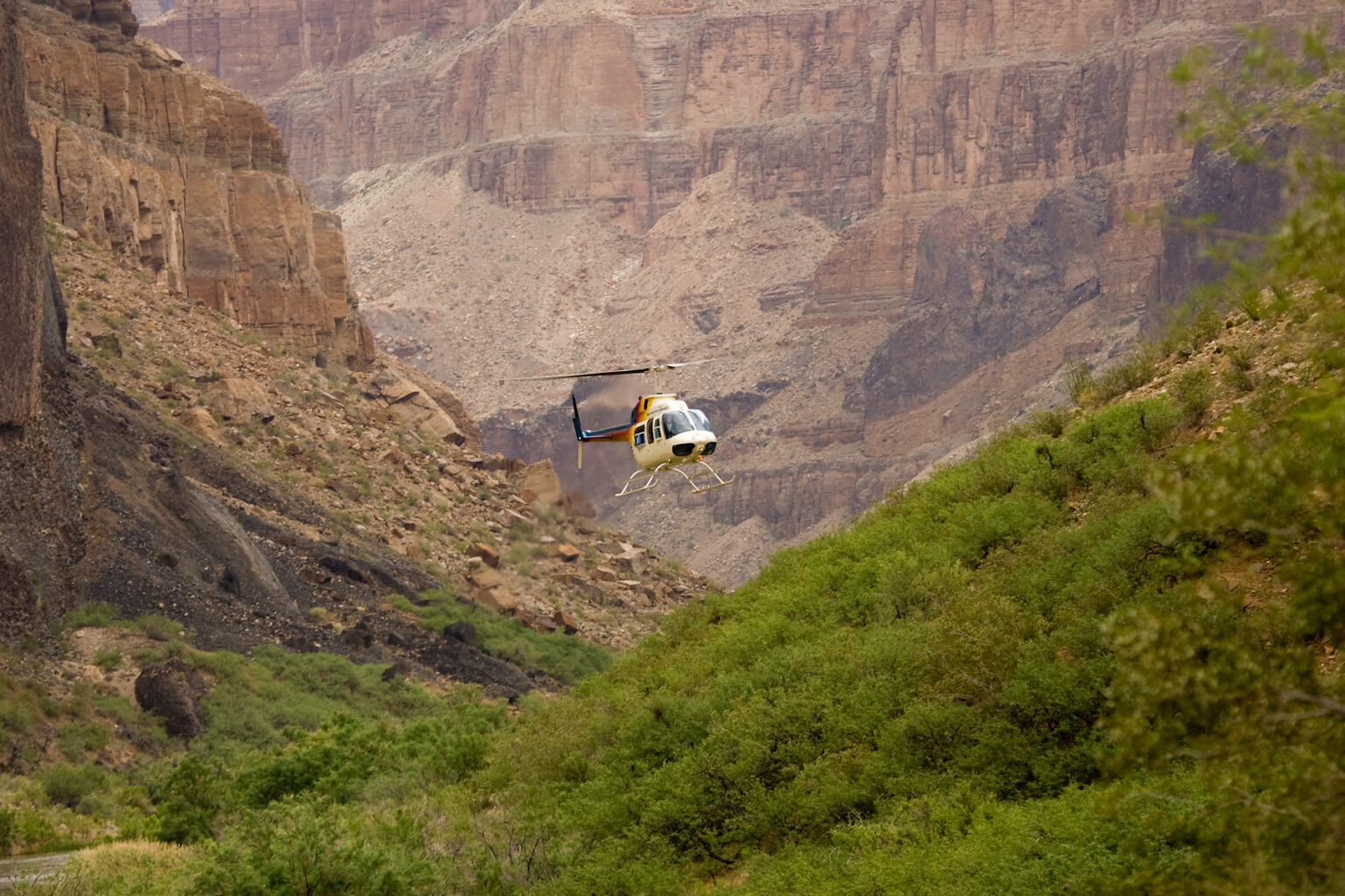 Helicopter approaches Whitmore Wash in Grand Canyon with OARS guests