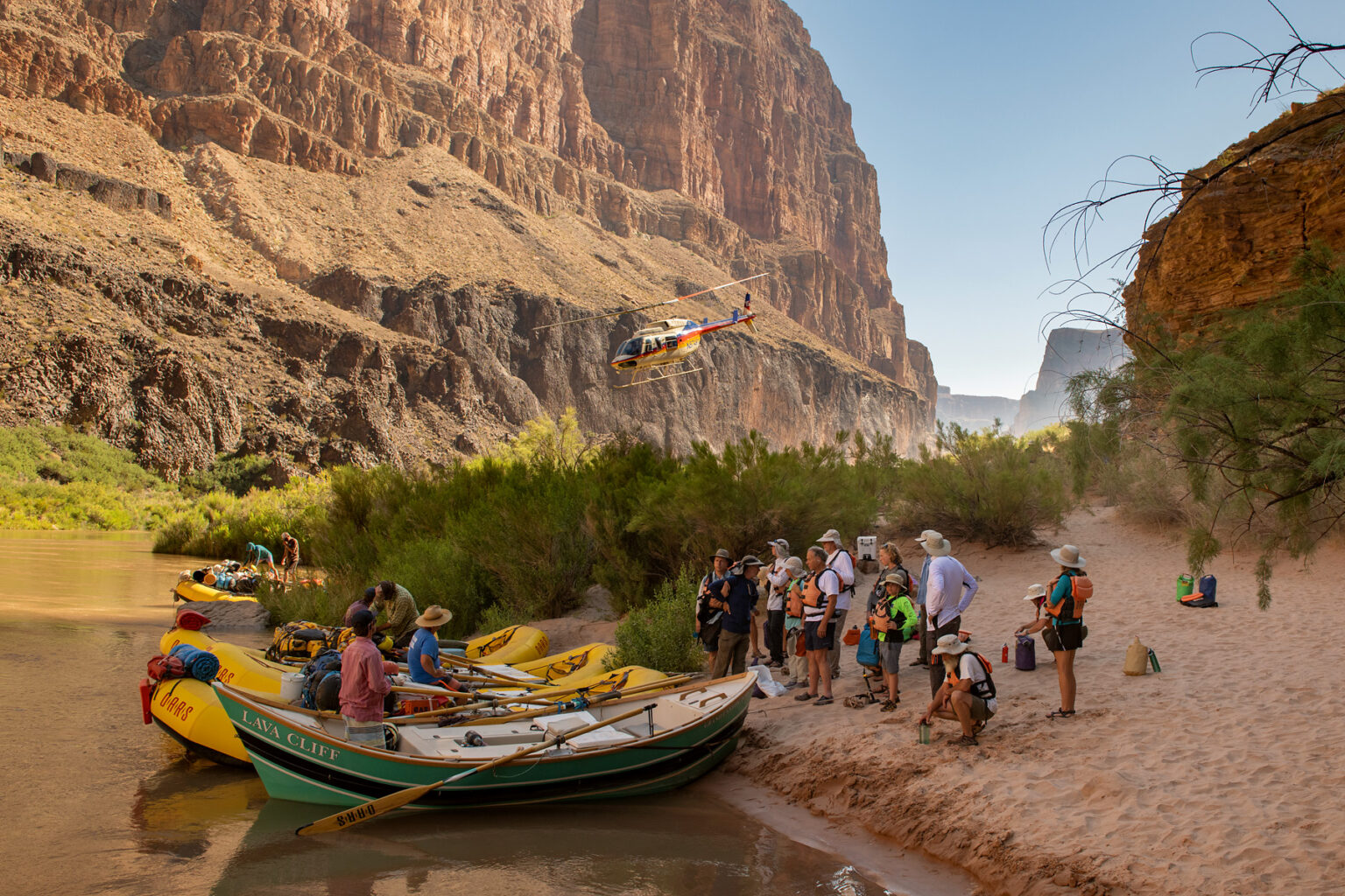 Helicopter leaves after dropping off OARS guests in Whitmore Wash for a rafting trip down the lower Grand Canyon