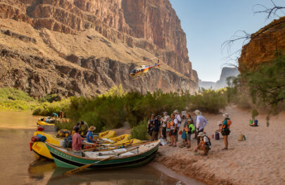 Helicopter leaves after dropping off OARS guests in Whitmore Wash for a rafting trip down the lower Grand Canyon