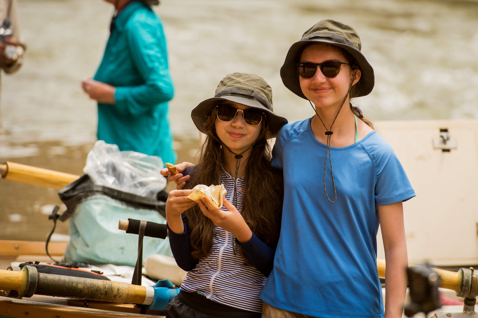 Sisters in sunglasses smile for camera on an OARS Grand Canyon river trip