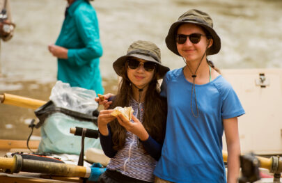 Sisters in sunglasses smile for camera on an OARS Grand Canyon river trip