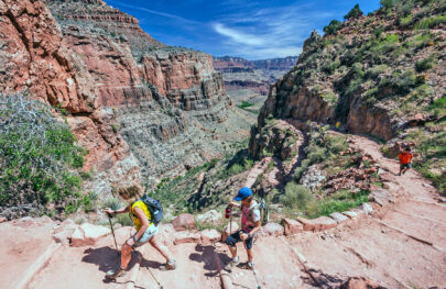 Three hikers ascending Bright Angel Trail in Grand Canyon