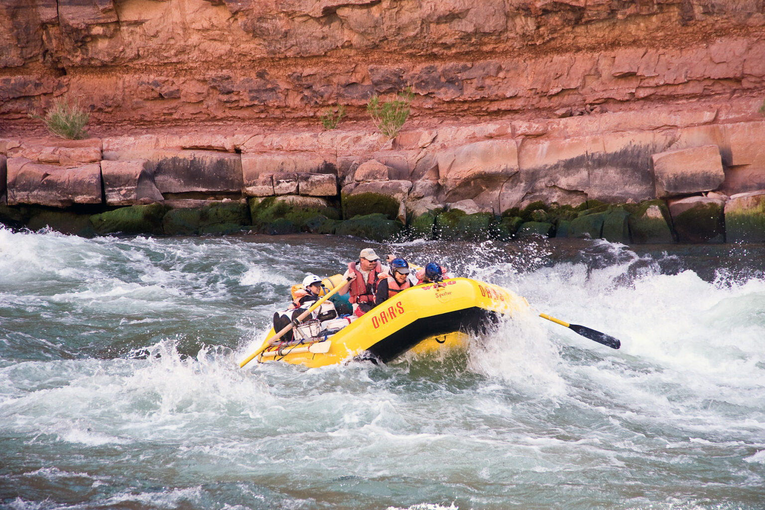 Yellow OARS raft in whitewater in Grand Canyon