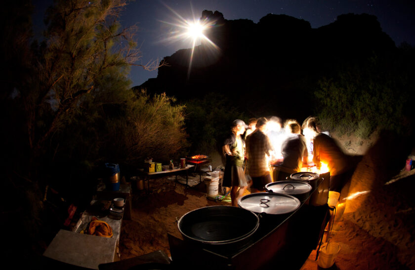 Guides prepare dinner by headlamp in Grand Canyon
