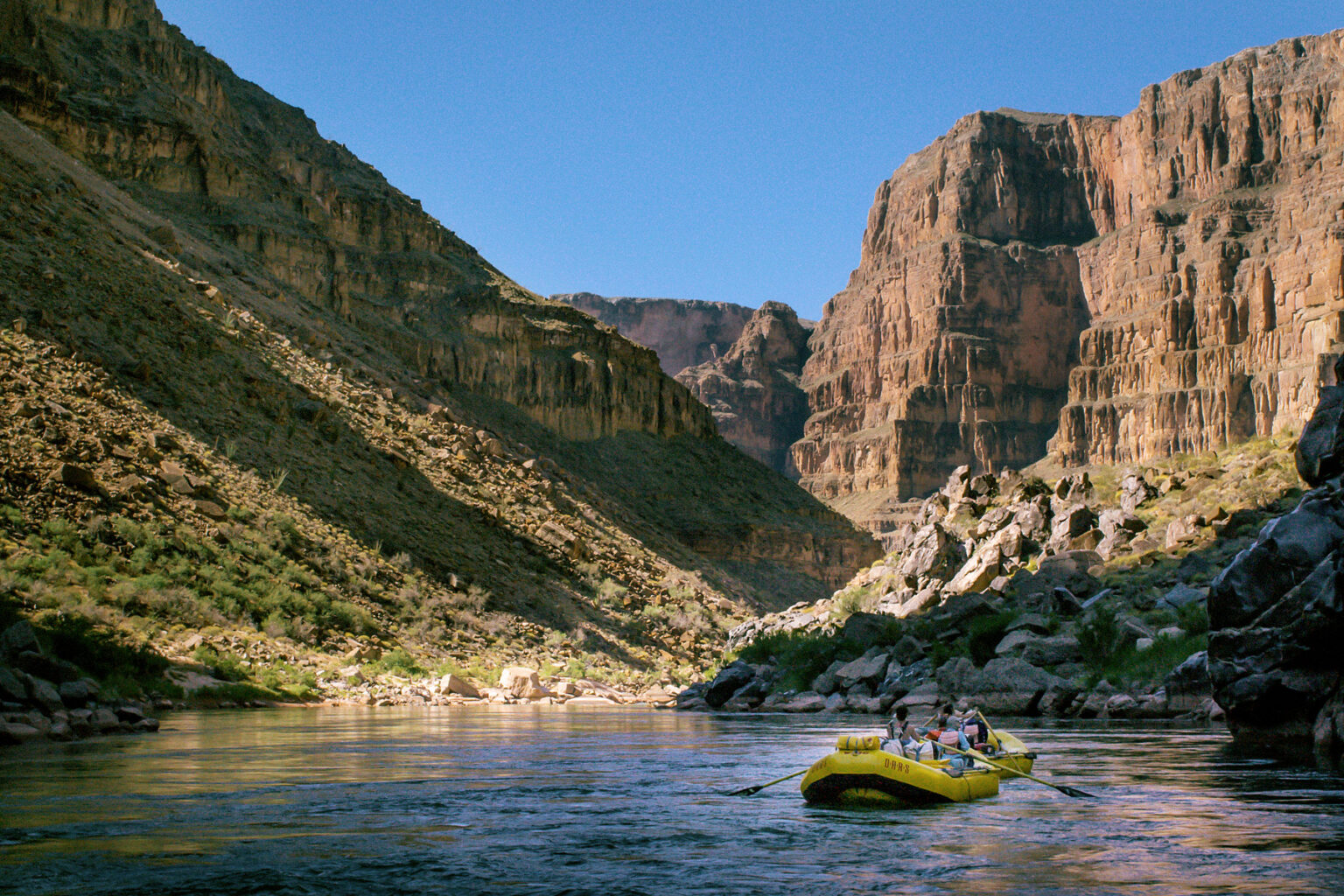 Yellow OARS rafts in lower section of Grand Canyon