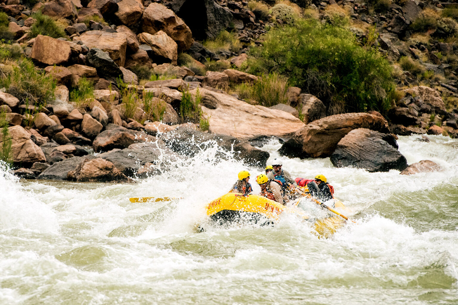 Yellow OARS raft in whitewater in Grand Canyon