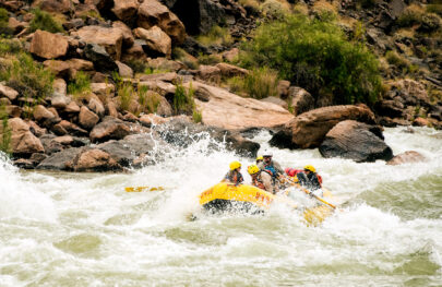 Yellow OARS raft in whitewater in Grand Canyon