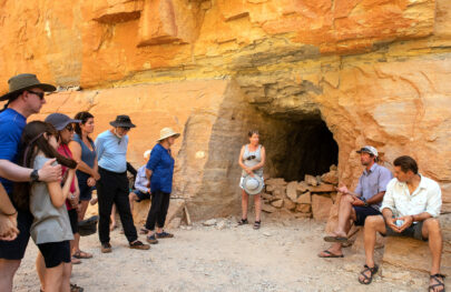 OARS guide provides interpretive talk to guests at an ancient granary near the Colorado River in Grand Canyon