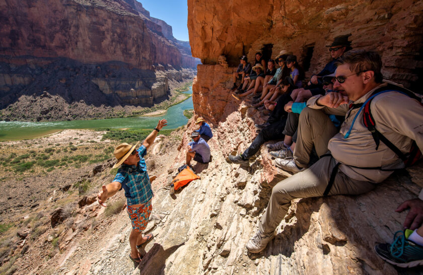 OARS guide provides interpretive talk to guests trying to stay out of the sun at the Nankoweap graneries high above the Colorado River in Grand Canyon