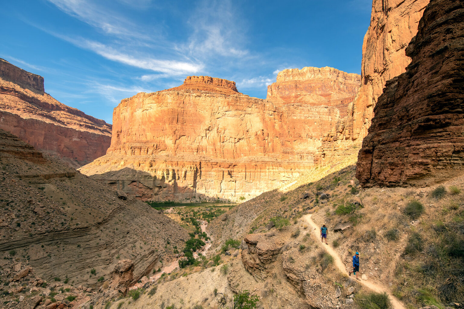 OARS guides on a side hike in Grand Canyon with Colorado River in the distance