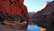 OARS raft and dory moored on a sandy beach in the late afternoon in Grand Canyon
