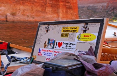 Notes and stickers on the inside of a waterproof hatch on an OARS dory