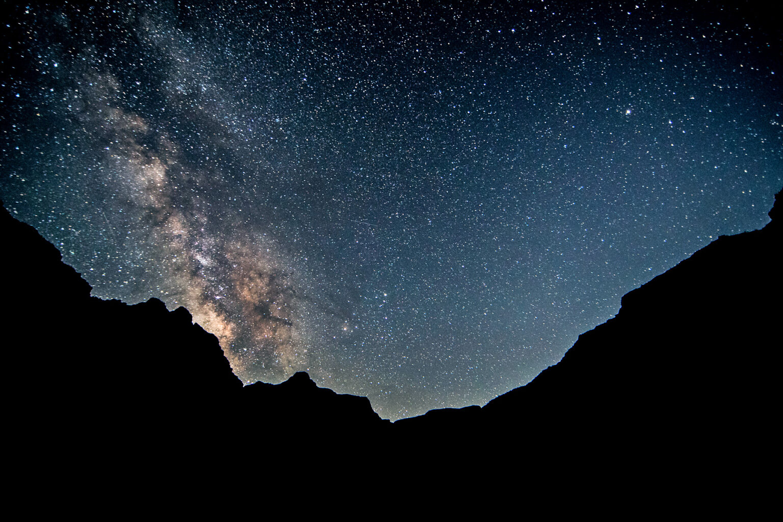 timed exposure of night sky above Grand Canyon with the Milky Way extremely pronounced