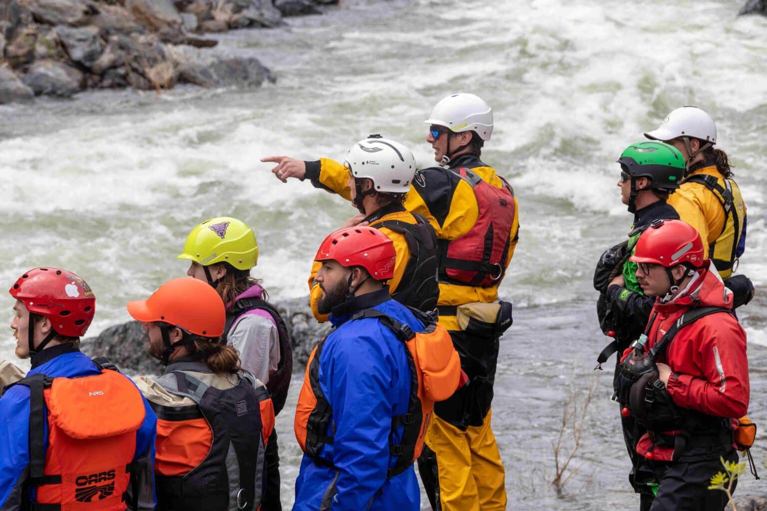 A group of guides scouts Split Rock Rapid on the Merced River.
