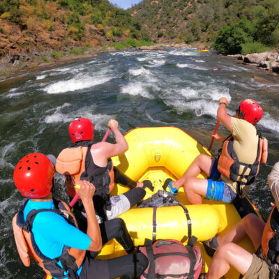 A group of paddlers in a yellow raft on the Chili Bar section of the South Fork American River in California