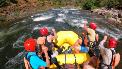 A group of paddlers in a yellow raft on the Chili Bar section of the South Fork American River in California