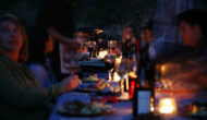 Guests eating by candle light on the Rogue River.