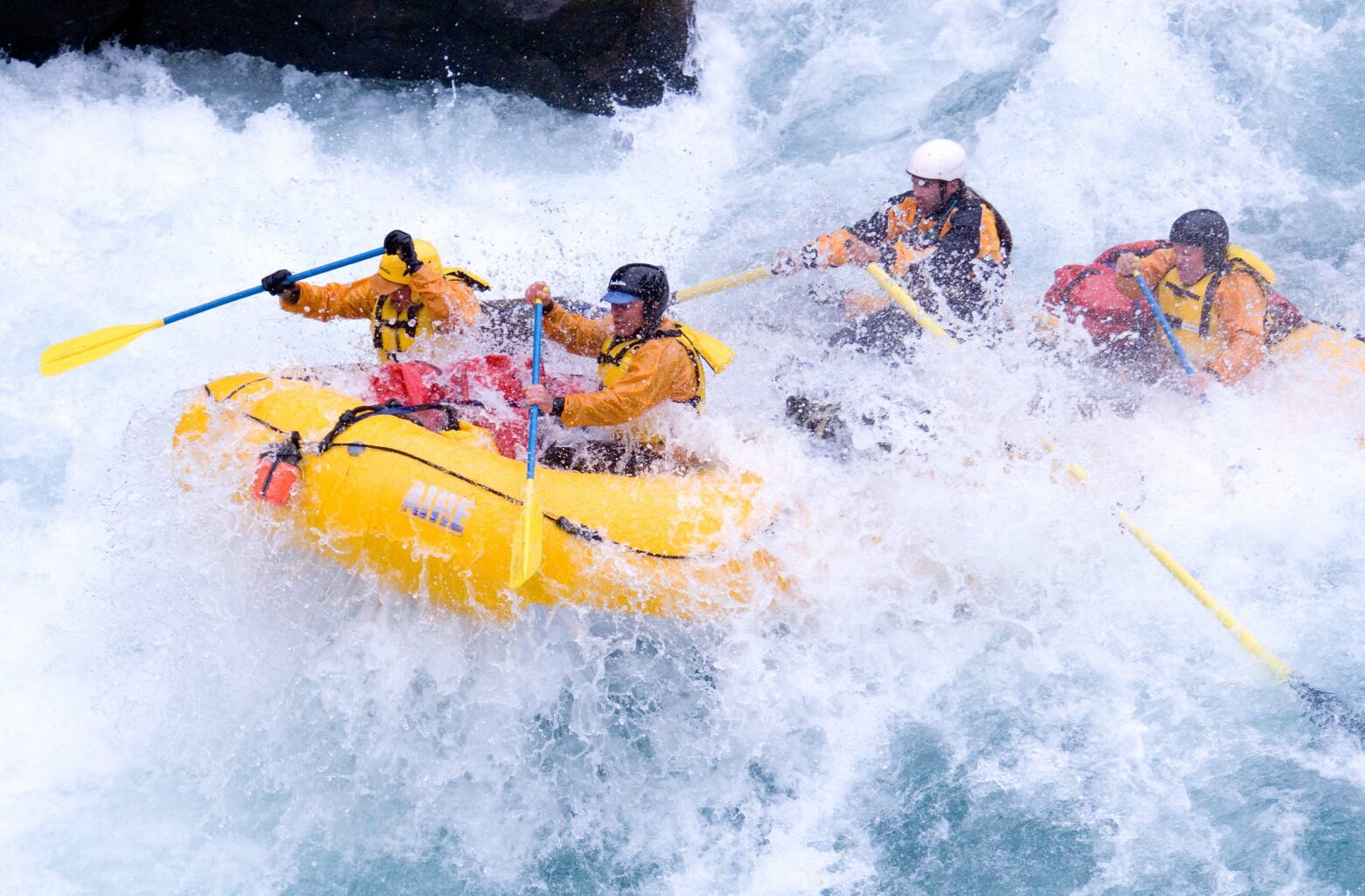 Four people white water rafting.