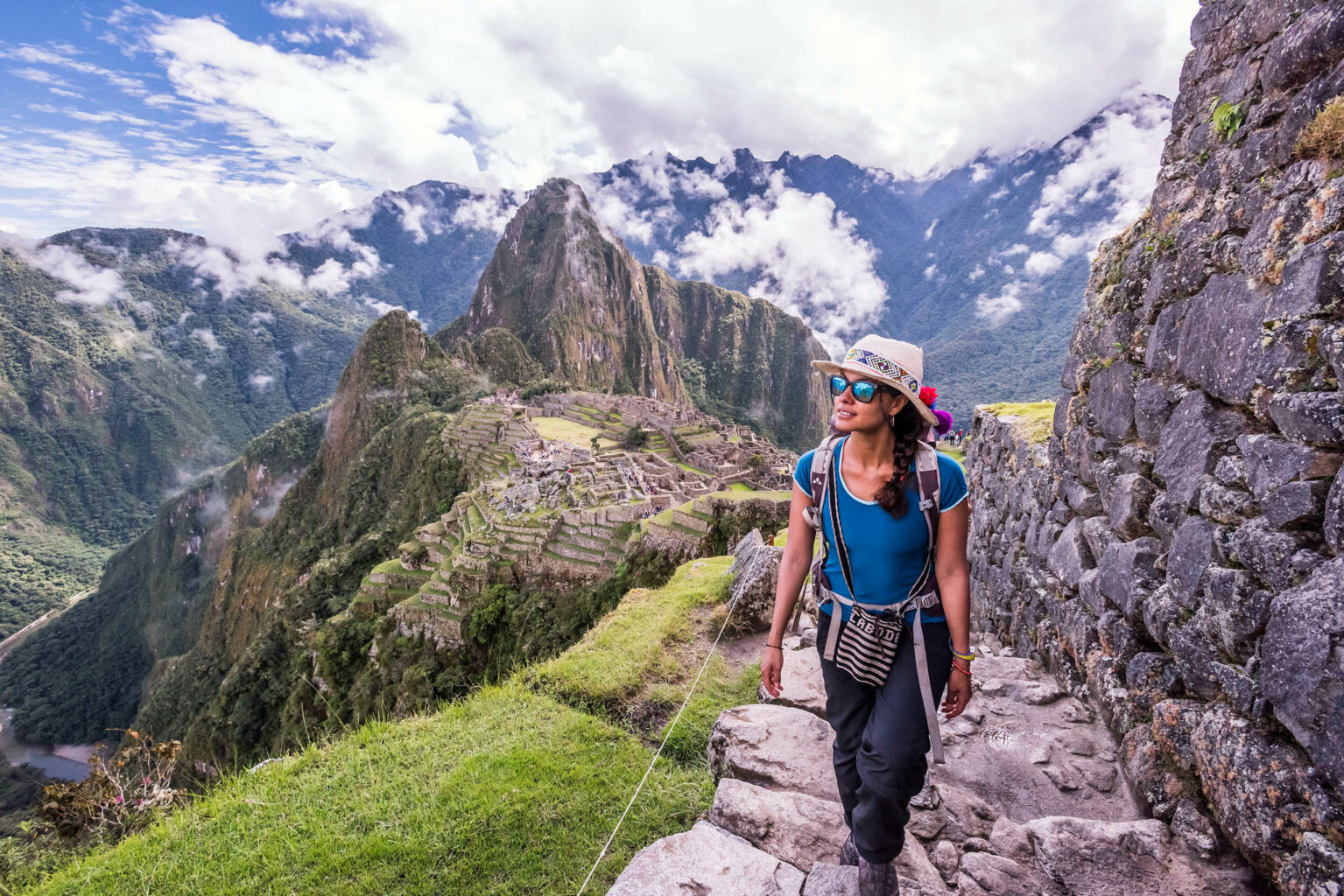 A woman explorers the ancient Incan empire of Machu Picchu.