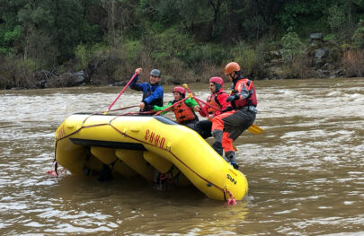 Guides doing raft flipping drills.