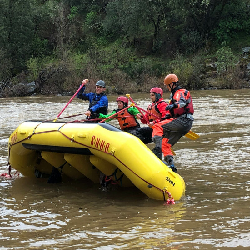 Guides doing raft flipping drills.