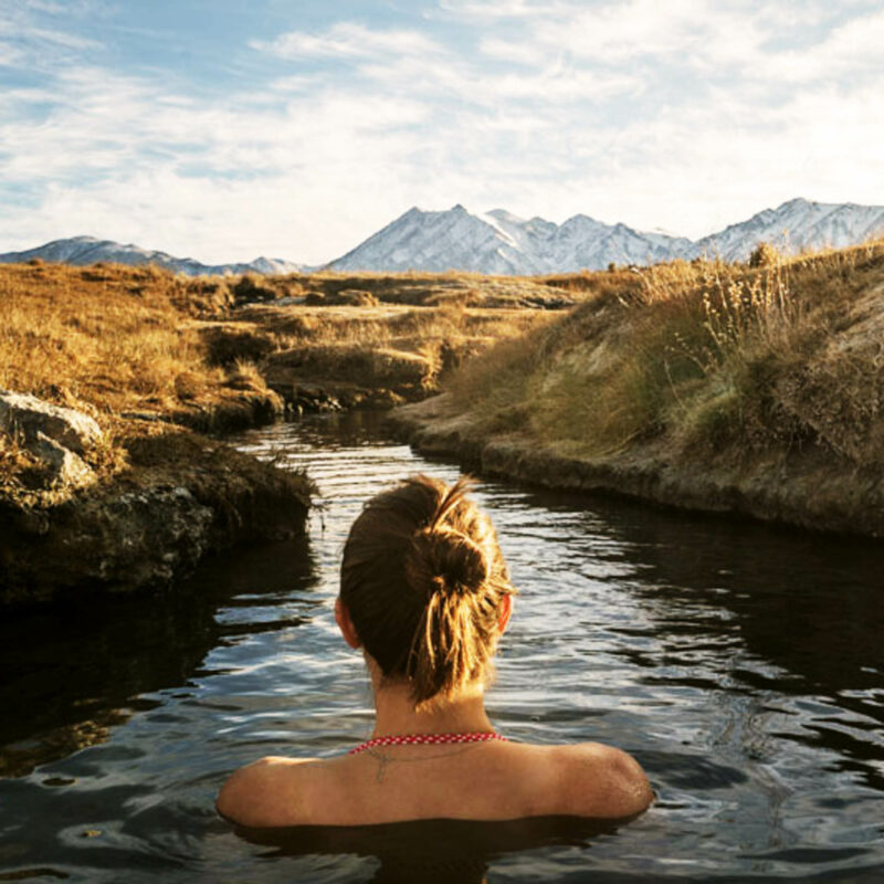 Woman in a river on the Los Angeles road trip.