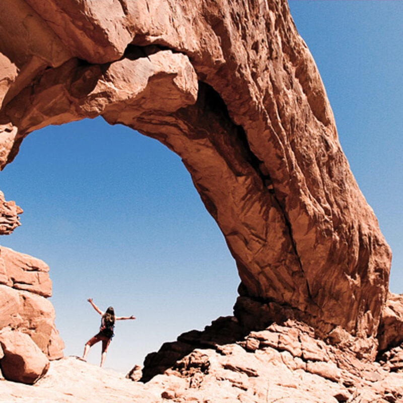 Woman under an arch in Moab.