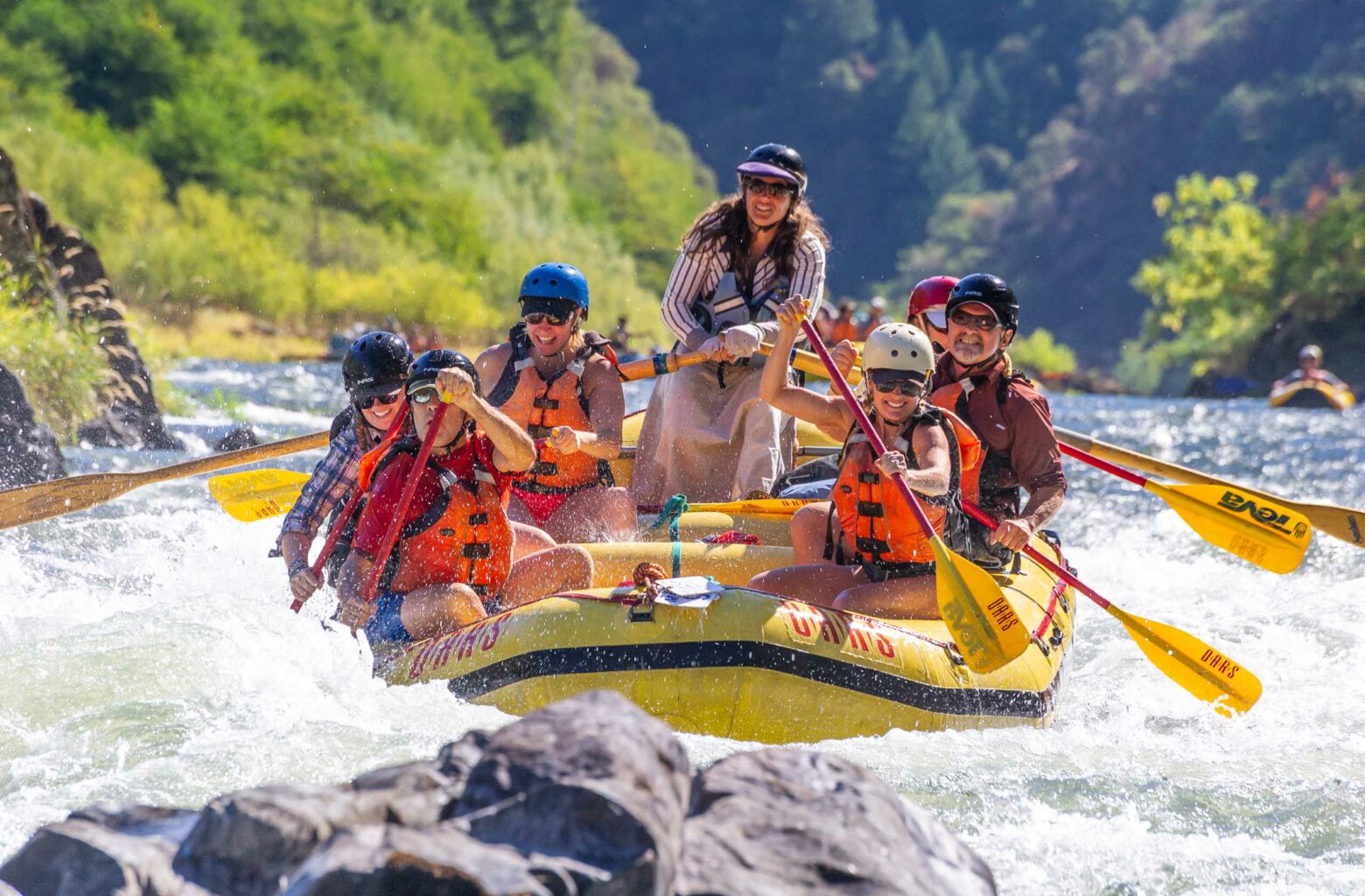 A group of people white water rafting.