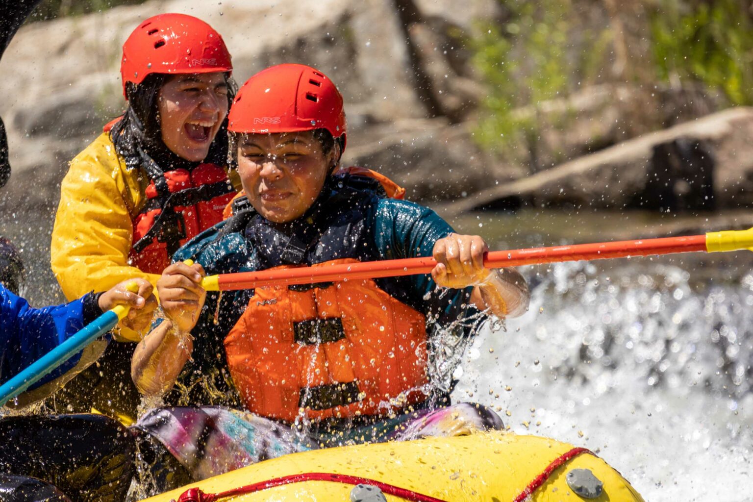 A group of people white water rafting at the Barking Dog Rapid.