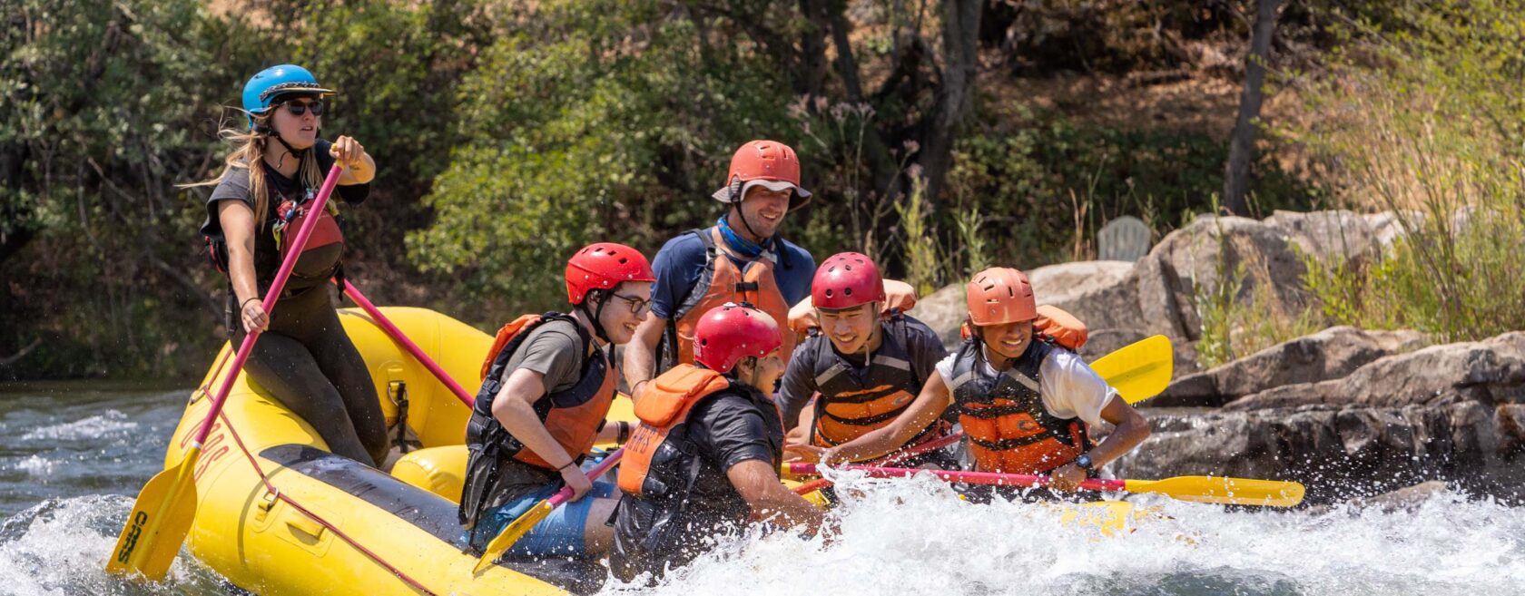 A group of people white water rafting.