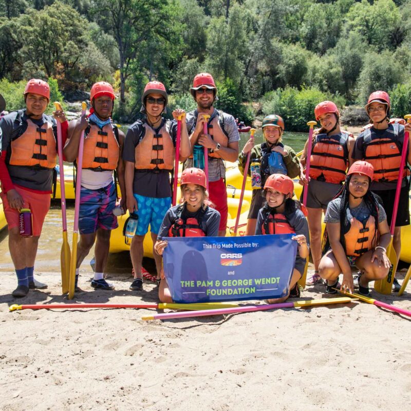A group of people ready to go rafting.