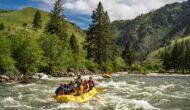 A guide maneuvers an oar raft with paddlers assisting on a Middle Fork of the Salmon River rafting trip.