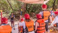 An OARS staff member teaching a group of people about safety.