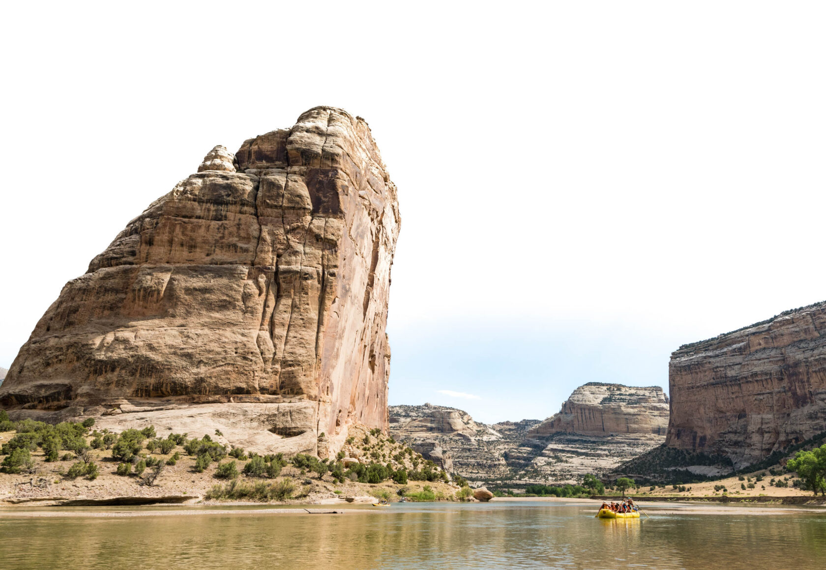 Rafting past Steamboat rock formation in Utah.