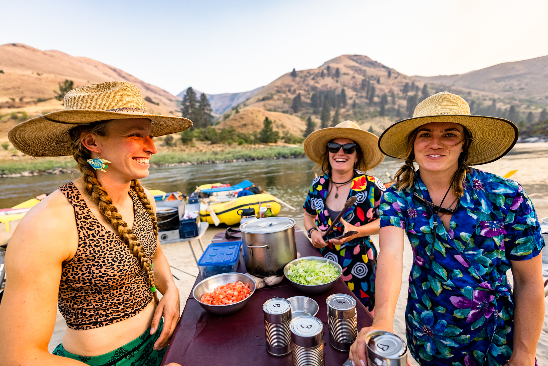 Three female river guides in big hats with big smiles
