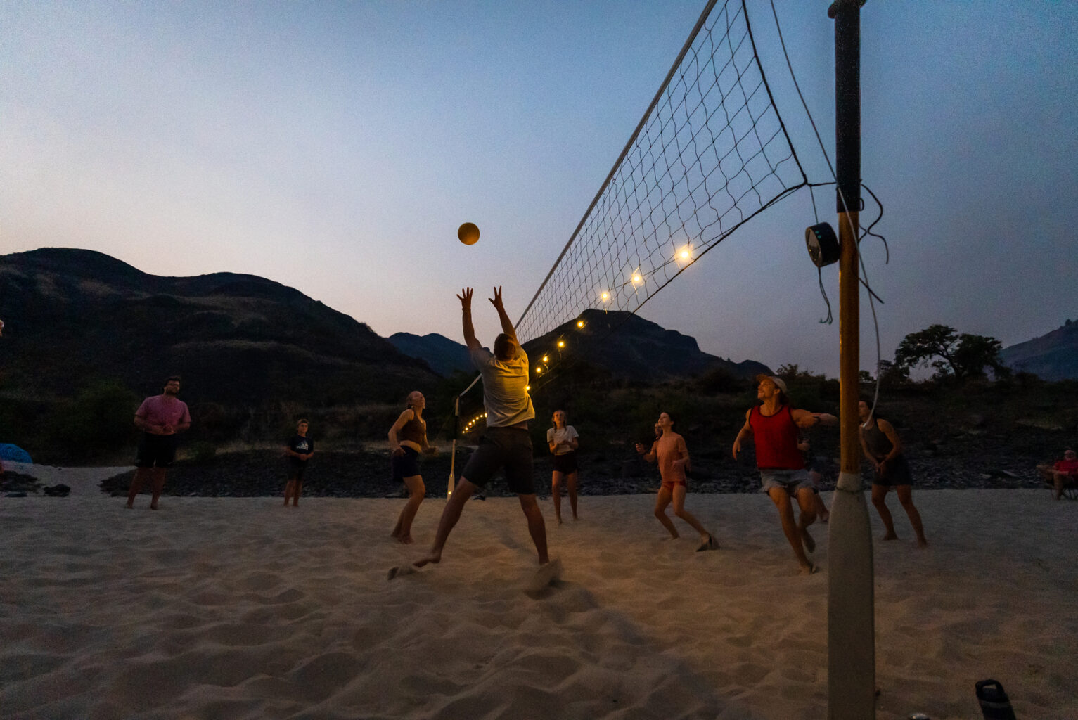 Luci solar lights illuminate an evening volleyball game on the Lower Salmon River