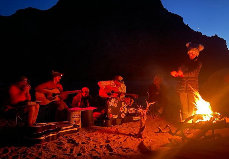 River guides playing music at camp on the Colorado River