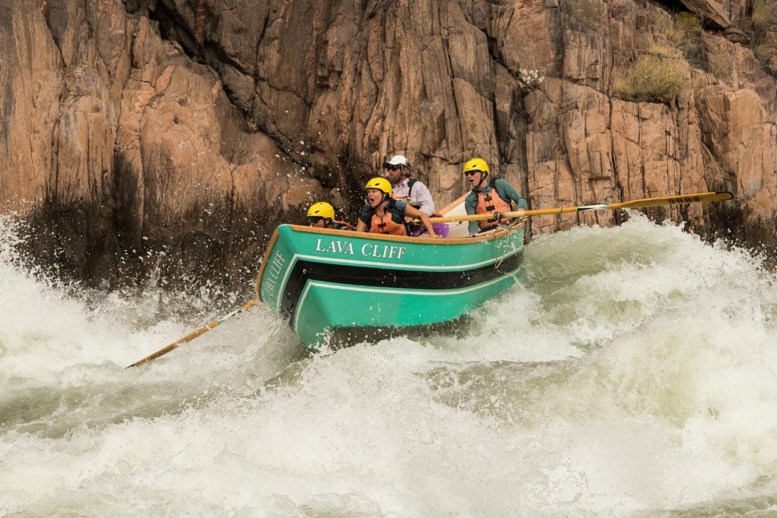 Passengers in a dory make it through a rapid on the Colorado River through Grand Canyon.