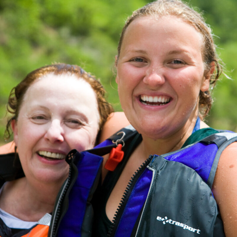 An OARS guide and her mom smile for the camera on a Rogue River trip.