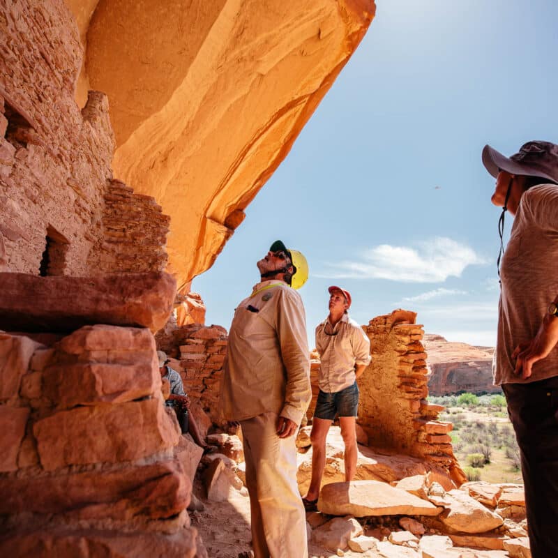 Guide and guests looking at a monument.