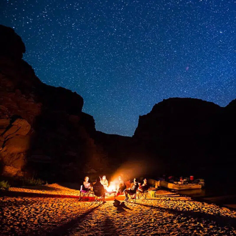 Group having a camp fire under the stars at Canyonlands National Park.