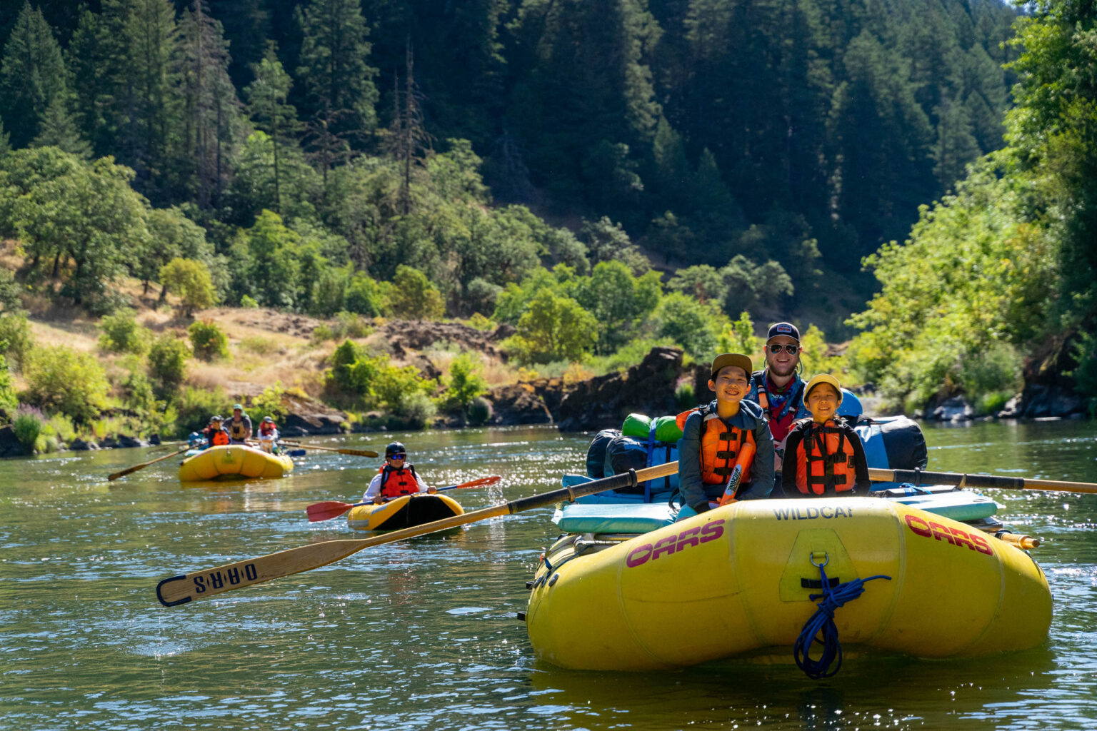 Groups of rafters having a good time on a river.