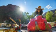 Woman in a hat packing a bag on a raft.