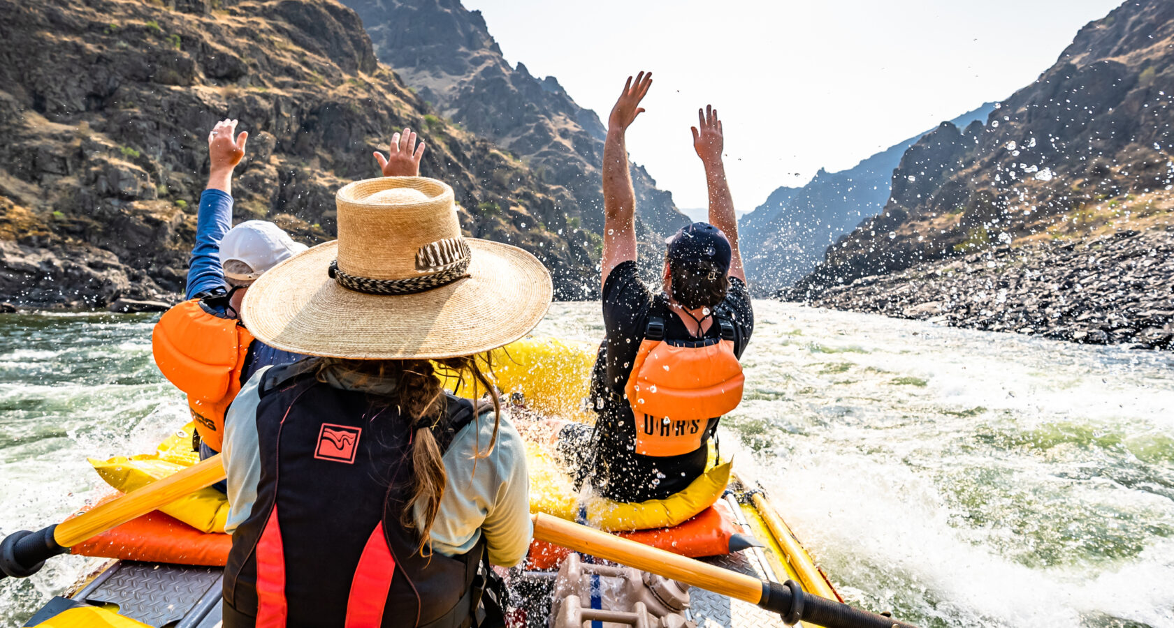 Rafters throwing their hands up while rafting Idaho's Lower Salmon River