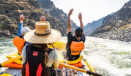 Rafters throwing their hands up while rafting Idaho's Lower Salmon River